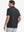 Back view from waist up showing the fit of BLACK 4 Way Stretch Jacquard Polo on model