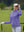 The model is wearing Women's Water-Resistant Stretch Fleece Lined Jacket lavender on the golf course.
