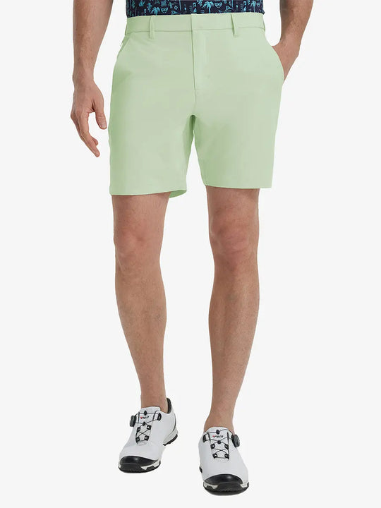 Front view of model’s lower body with hands in pockets, wearing Player Fit Versatile Solid Shorts 7 Inch – LIGHT GREEN
