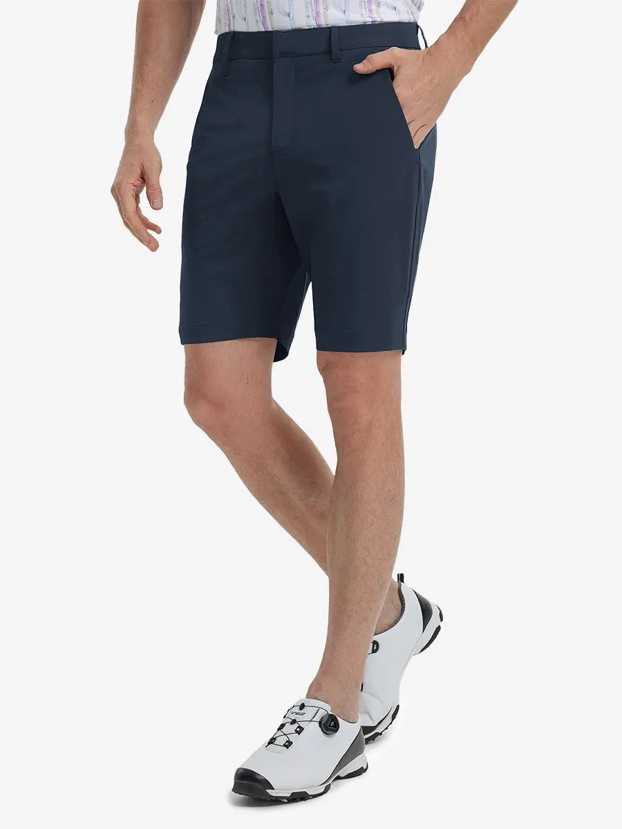 Front view of model’s lower body with hands in pockets, wearing Player Fit Versatile Solid Shorts 9 Inch – NAVY