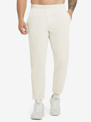 Model wearing Water Resistant Comfy Fleece Golf Joggers in cream, lower body front view