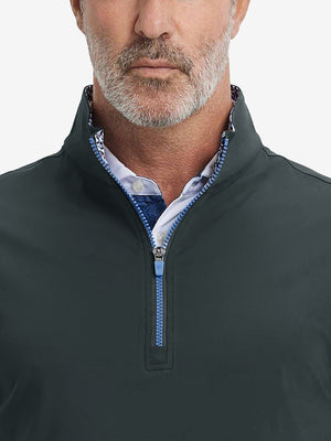 Close-up from nose to chest, showing collar detail and zipper of the dark grey golf vest.