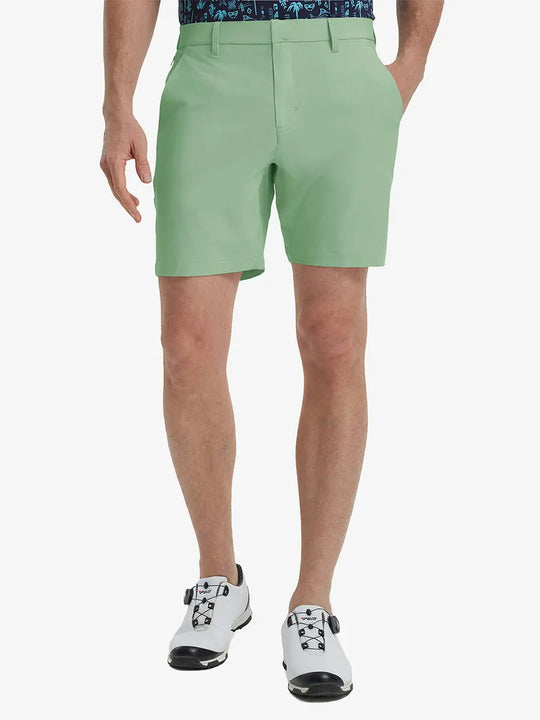 Front view of model’s lower body with hands in pockets, wearing Player Fit Versatile Solid Shorts 7 Inch – BERYL GREEN