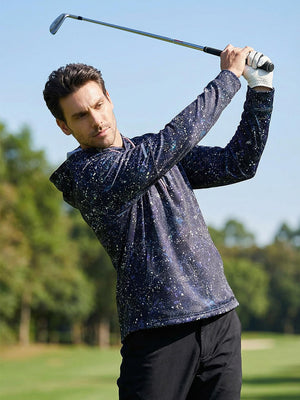 Model swinging a golf club on course, styled in trendy print fleece hoodies with splatter