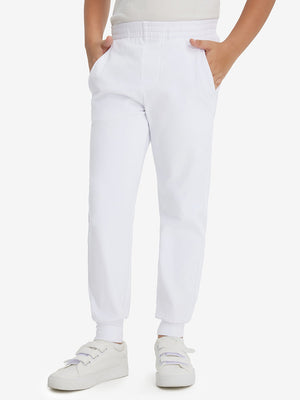 Model wearing white fleece stretch water resistant boys joggers, front view showing lower body and pants.
