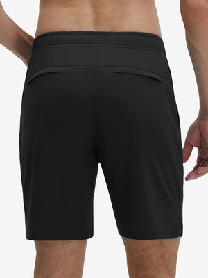 Back lower body shot of model wearing black breathable running shorts with 4 zipper pockets