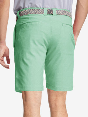 Back view of youth in mint green Heather Performance Golf Shorts, highlighting rear design and fit