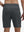 Back lower body shot of model wearing dark grey breathable running shorts with 4 zipper pockets