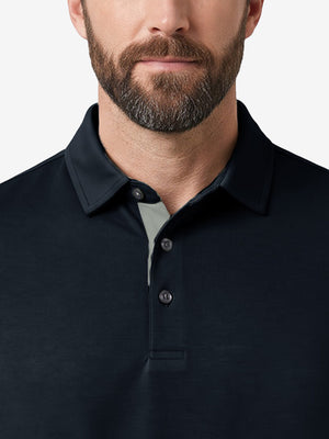 Front view from nose to chest of model wearing navy  ultra-comfort slim fit roma knit polo shirts