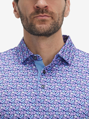 Front view from nose to chest of model wearing pink purple flower performance quick dry print golf polos