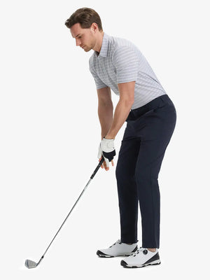 Full front view of model in Performance Water Resistant Pants NAVY，ready for golf with club in hand.
