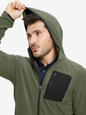 Model wearing hood and pulling it slightly, dressed in full zip fleece hoodied jacket in green.