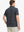 Back half-body view of model wearing DARK GREY STRIPE Stylish Performance Golf Polo