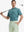 MAELREG Men's Performance Jersey Print Polo in Dark Green Leaf – front half-body with golf pose