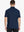 Back view half-body of model in NAVY Ventilated Pique Performance Polo