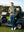 Model leaning on golf cart on course, wearing water-resistant fleece lined pants in saxony blue