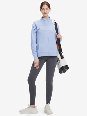Women's Water-Resistant Stretch Fleece Lined Jacket in light grayish blue , model holding golf bag