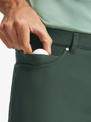 OLIVE GREEN 4-way Stretch Performance Solid Shorts, front pocket holding golf ball detail, 7 Inch