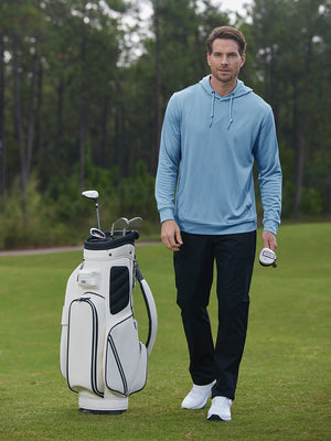 Model holding golf ball beside golf bag in classic heather pullover hoodies with 2 pocket, light blue melange