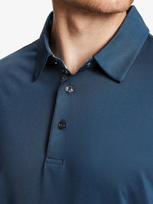 Male model wearing the Blue Everyday Classic Solid Polo, front view from nose to chest
