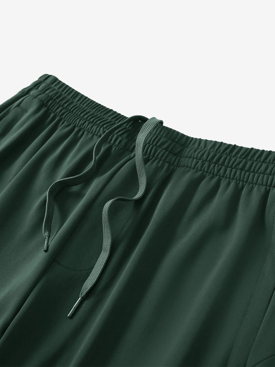 Angled view of lightweight women's stretchy joggers sweatpants waistband displayed in forest green.