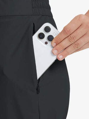 Detail shot of front side pocket holding an iPhone in BLACK Women's 7/8 Ankle Golf Track Pants.