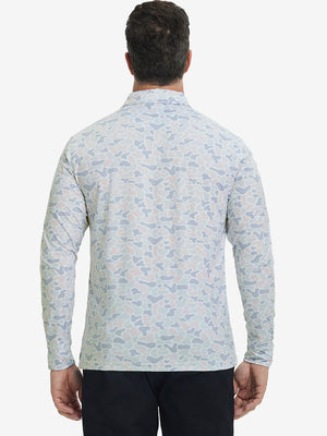 Back upper body view of the lightweight print polo in brown & gray camo, model turns slightly with relaxed pose.