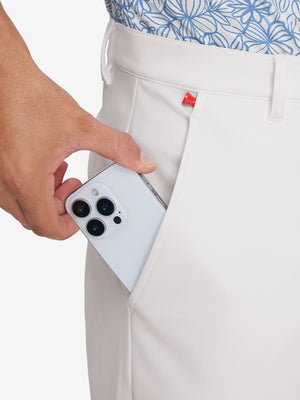Side pocket detail of Golf Lightweight Fleece Lined Dress Pants in oyster gray, holding smartphone