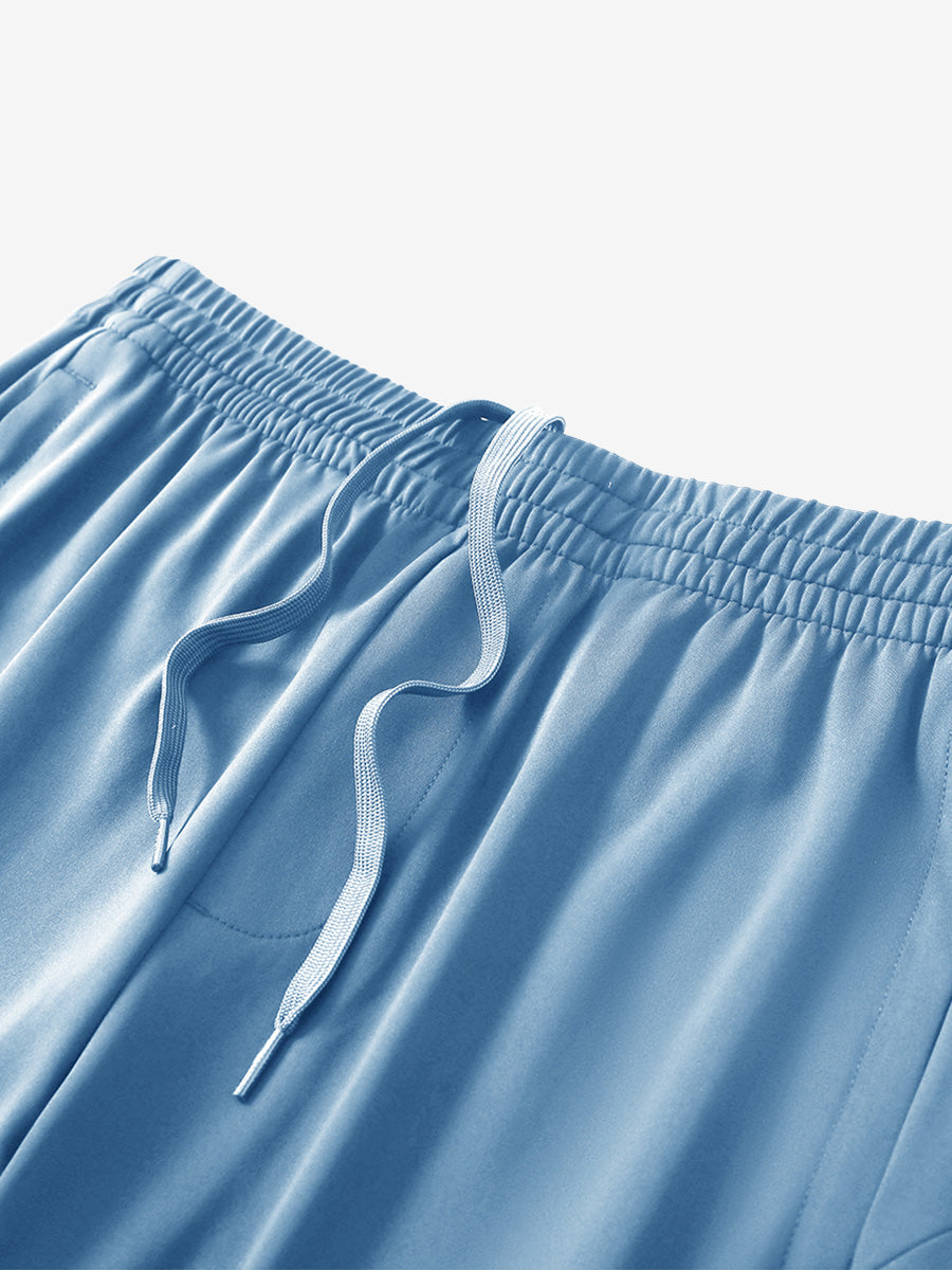 Angled view of lightweight women's stretchy joggers sweatpants waistband displayed in misty blue.