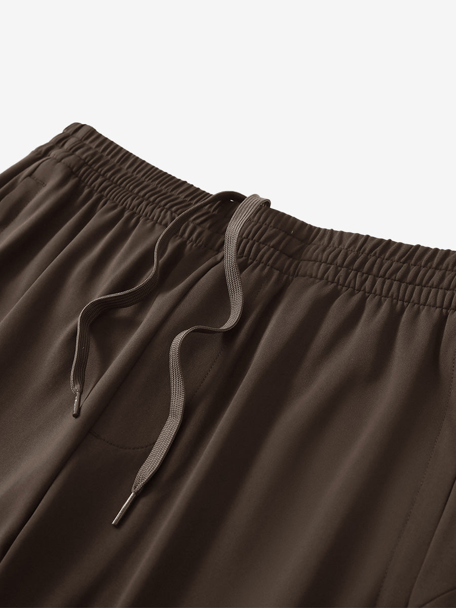 Angled view of lightweight women's stretchy joggers sweatpants waistband displayed in coffee brown.