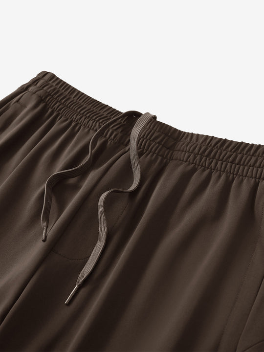 Angled view of lightweight women's stretchy joggers sweatpants waistband displayed in coffee brown.