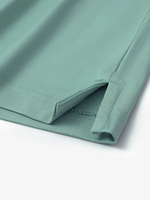 Close-up of hem slit detail on Everyday Solid Jersey Polo in BERYL GREEN, showing fine craftsmanship.