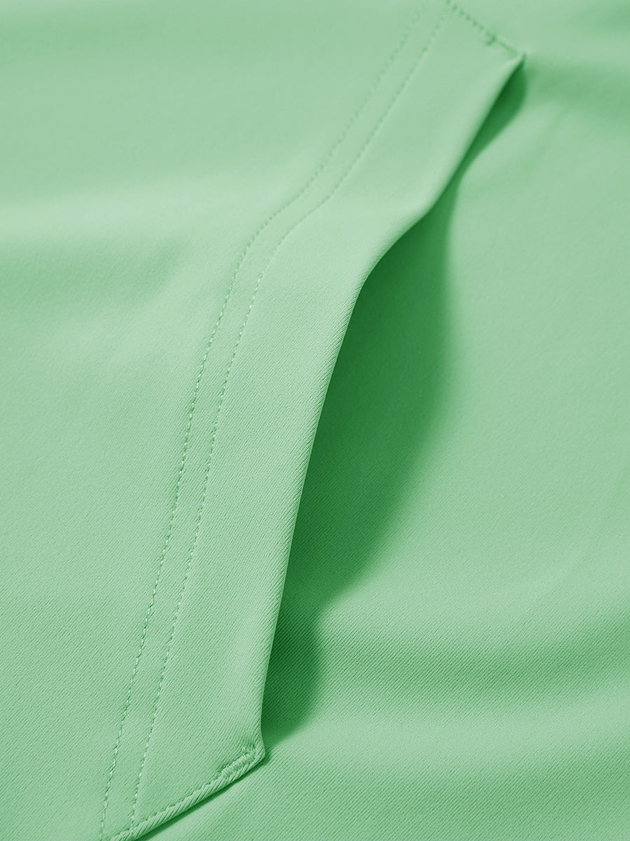 Close-up of single pocket detail on youth long sleeve hoodied with kangaroo pocket in light green, showing stitching.