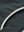 Side pocket detail of the mock neck quarter button golf pullover in dark grey, practical design feature.