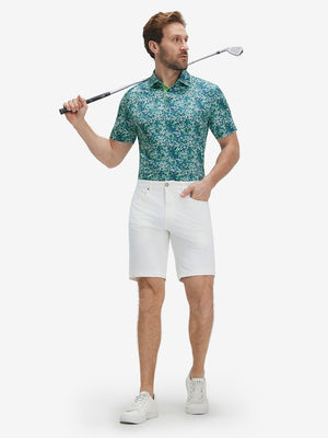 Model holding golf club in Performance quick dry print golf polos, navy green floral