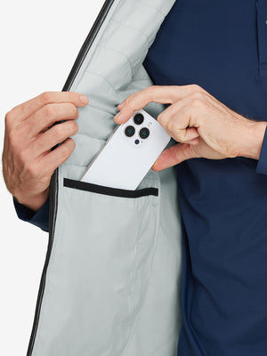 Inner pocket detail of Lightweight Water Resistant Puffer Vest in light grey heather, holding smartphone