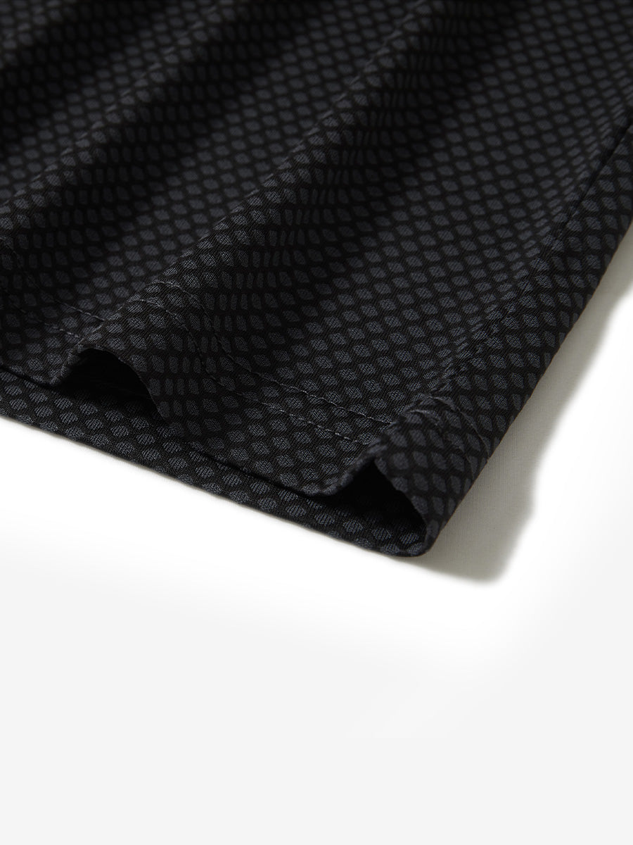 Hem detail of jacquard quarter zip pullover in dark grey/black, focusing on stitching and side vent finish.