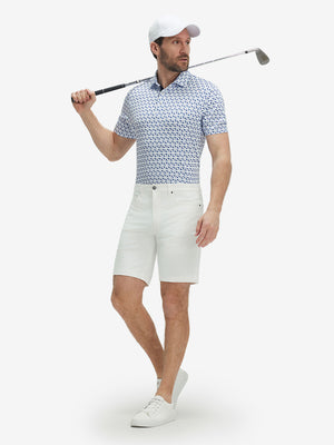 Full-body shot of model holding a golf club in white navy dolphin performance quick dry print golf polos