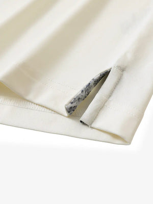 Close-up of side slit hem detail on CREAM Long Sleeve Solid Jersey Polo