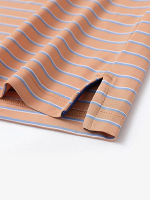 Hem slit detail of ORANGE/CAROLINA BLUE STRIPE Polo with smooth fabric edge