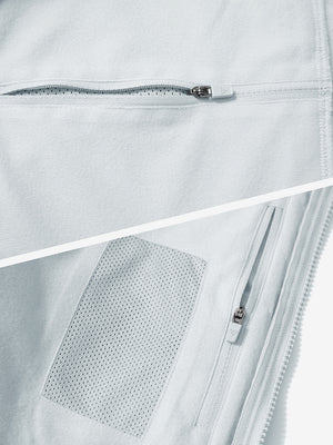 Close-up of the zipper detail of light gray winter thermal outdoor water resistant fleece jacket