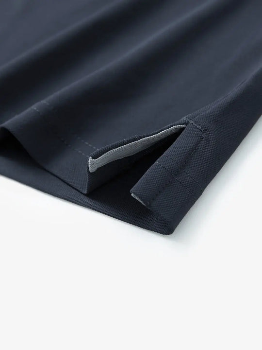 Detail shot of hem opening on DARK GREY Ventilated Pique Performance Polo