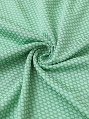 Close-up of light green your favorite jacquard polo fabric showing textured knit and soft finish.