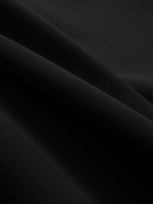 Close-up texture of black breathable running shorts with 4 zipper pockets fabric showing weave detail