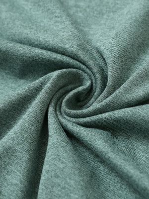 Close-up fabric detail of skin-friendly long sleeve melange polo, soft blend texture with dark green heather tone