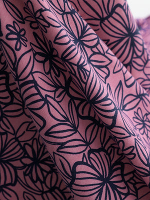 Fabric detail of Popular heather print polo with soft blended texture in mauve flower
