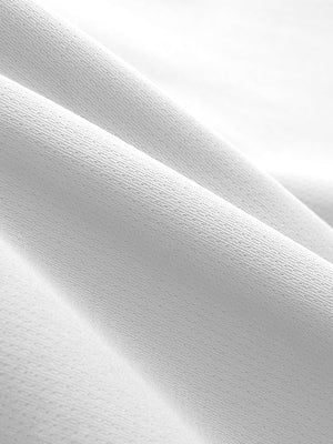 Close-up texture of white breathable running shorts with 4 zipper pockets fabric showing weave detail