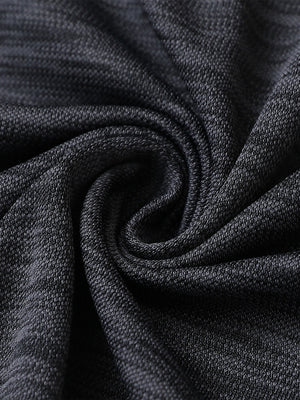 Close-up of dark greyblack heather texture polo fabric showing soft surface.