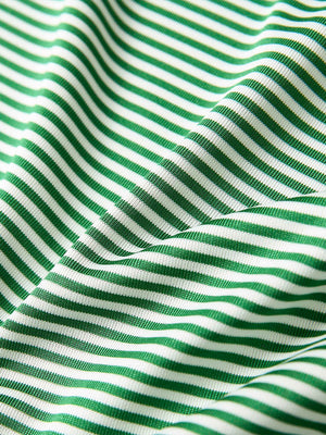 Close-up of emerald stripe performance cooling polo - youth fabric texture.