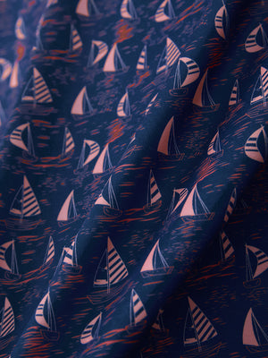 Macro view of the navy sailboat 4 way stretch print collared polo shirt fabric, showcasing the unique print design
